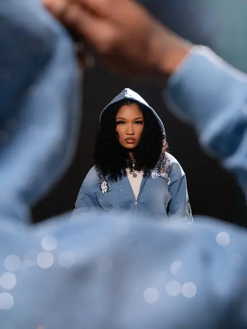 Model in the Gamma Blue Written In Stone hoodie, hood up