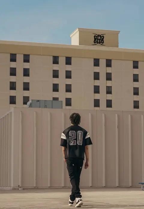 Varsity tee number 20 on a rooftop